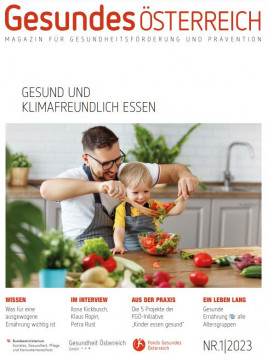 Titelblatt des Magazins. Foto: Mann und Kind beim Kochen