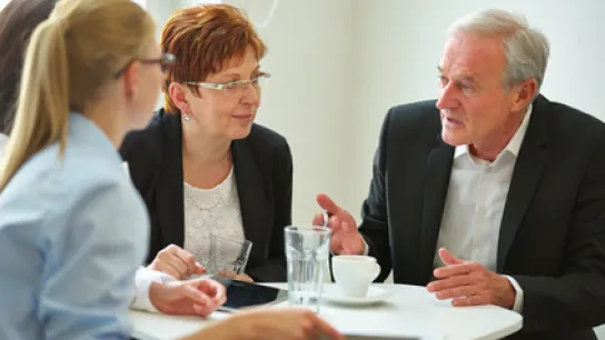 Foto: Drei Menschen sprechen miteinander